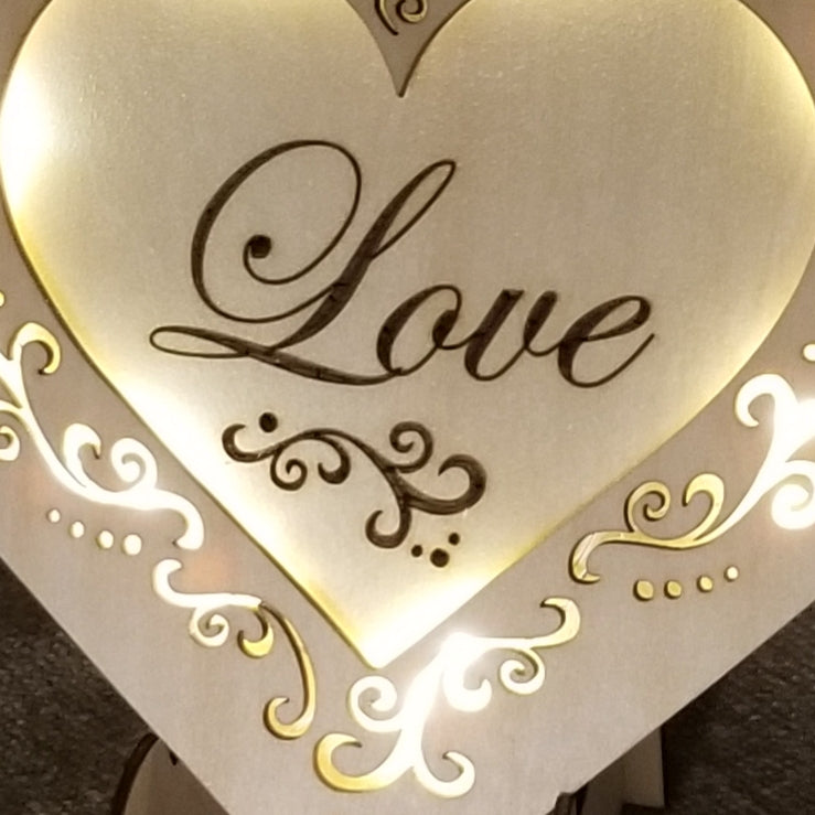 "Love" conversation heart with filigree cuts and LED lights.