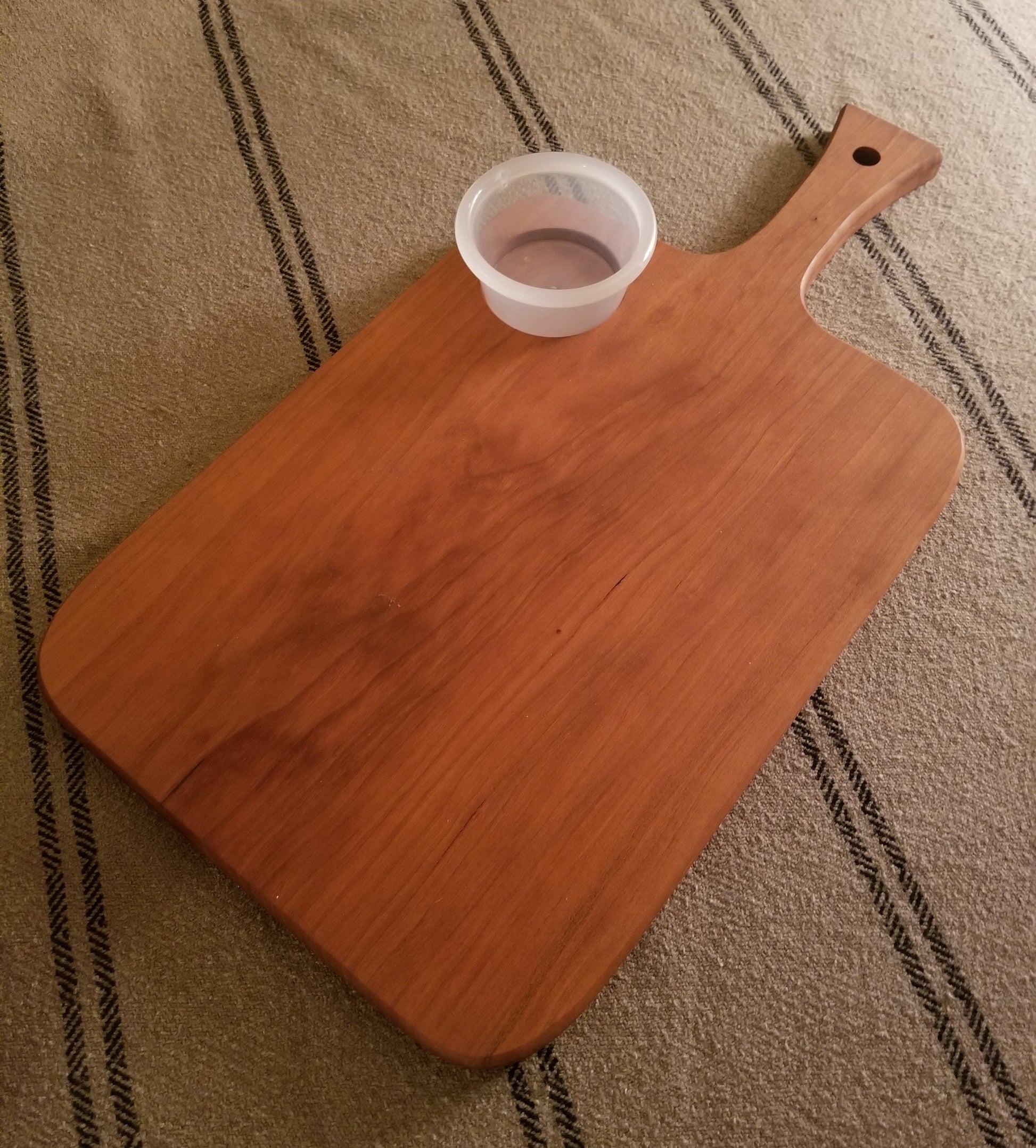 Back side of Custom engraved engagement cutting/serving board. Personalized with names, date and a special message. Shown in Cherry.