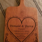Custom engraved engagement cutting/serving board. Personalized with names, date and a special message. Shown in Cherry,