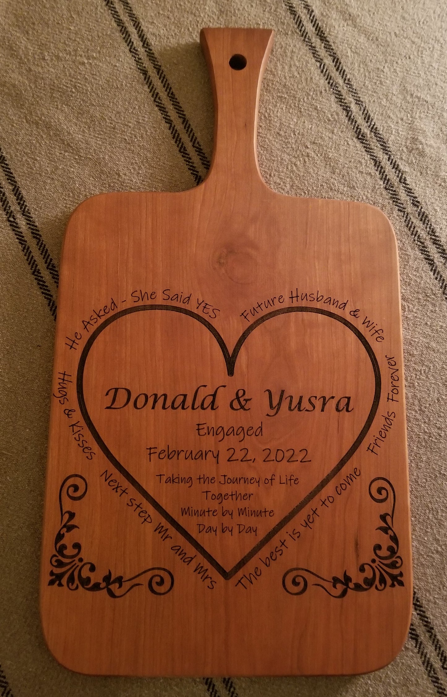 Custom engraved engagement cutting/serving board. Personalized with names, date and a special message. Shown in Cherry,
