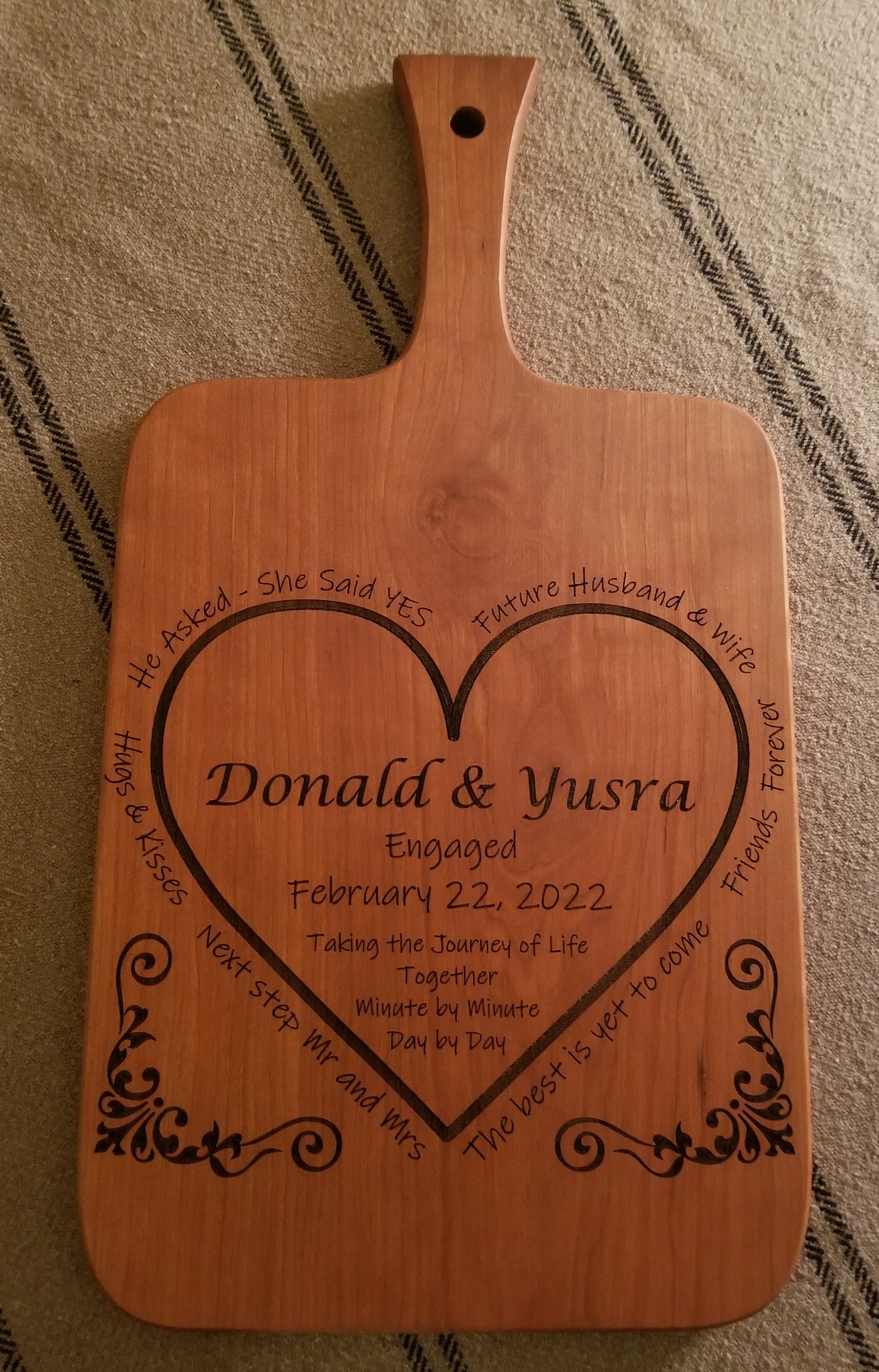 Custom engraved engagement cutting/serving board. Personalized with names, date and a special message. Shown in Cherry,