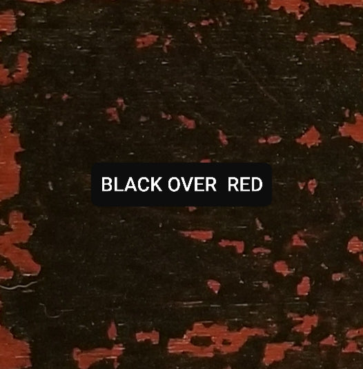 Paint swatch Black over Red, aged and distressed.