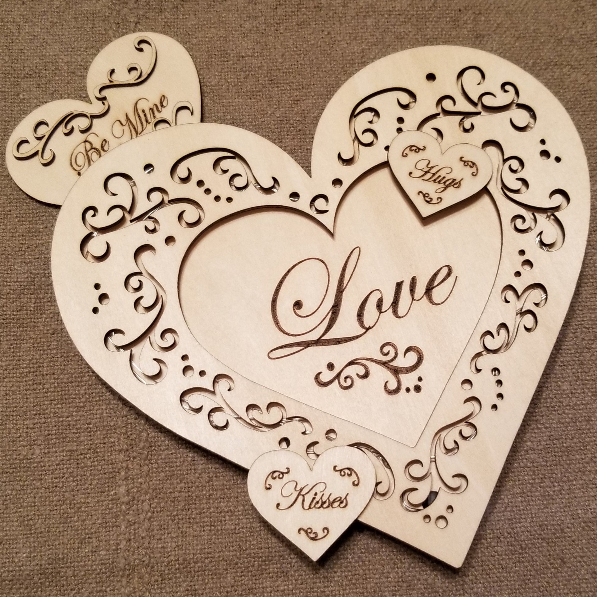 Layered "Love" conversation heart with filigree cuts and LED lights.