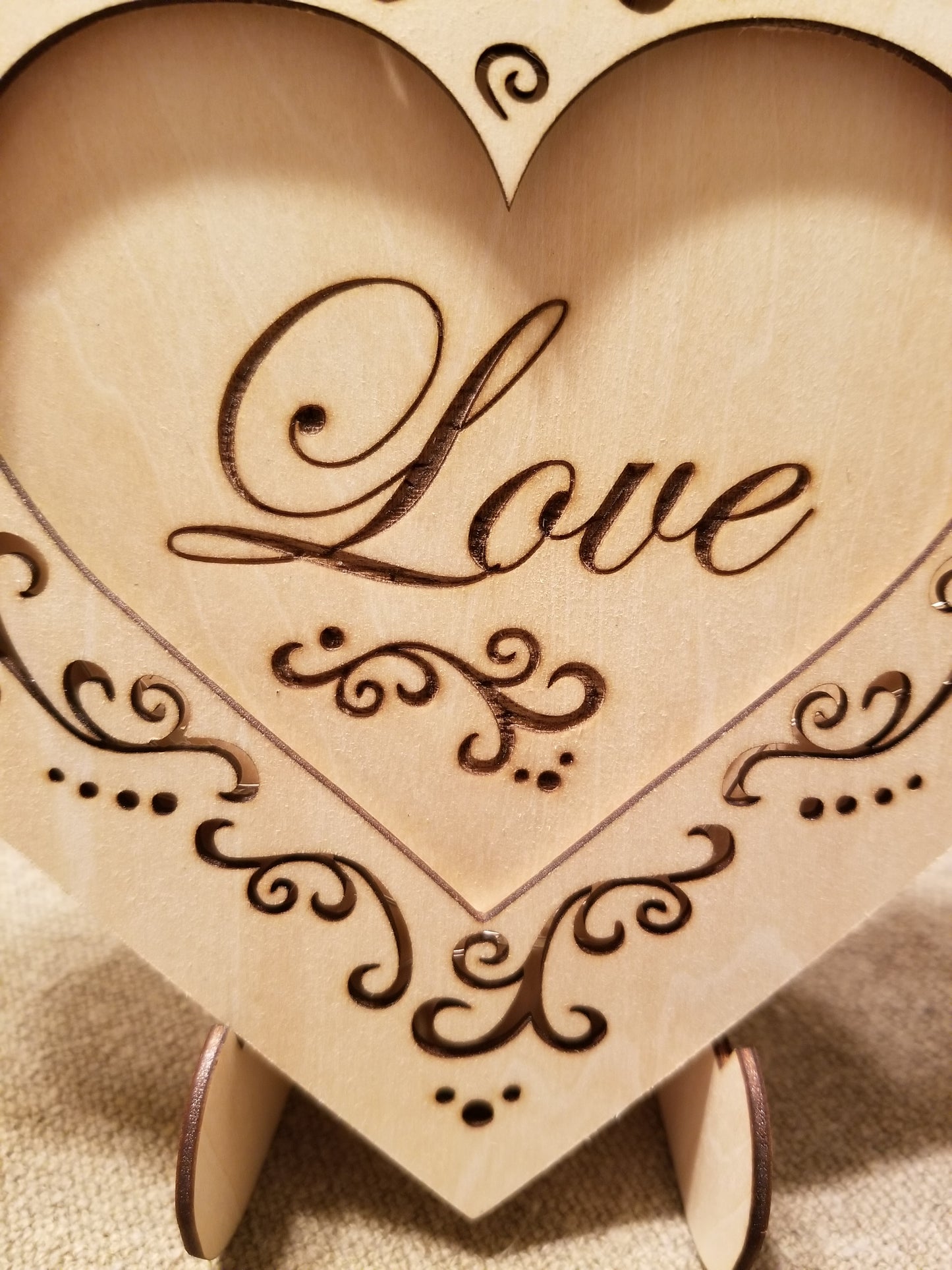 "Love" conversation heart with filigree cuts and LED lights. 