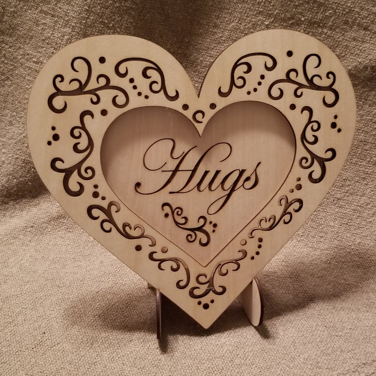 "Hugs" conversation heart with filigree cuts and LED lights. 