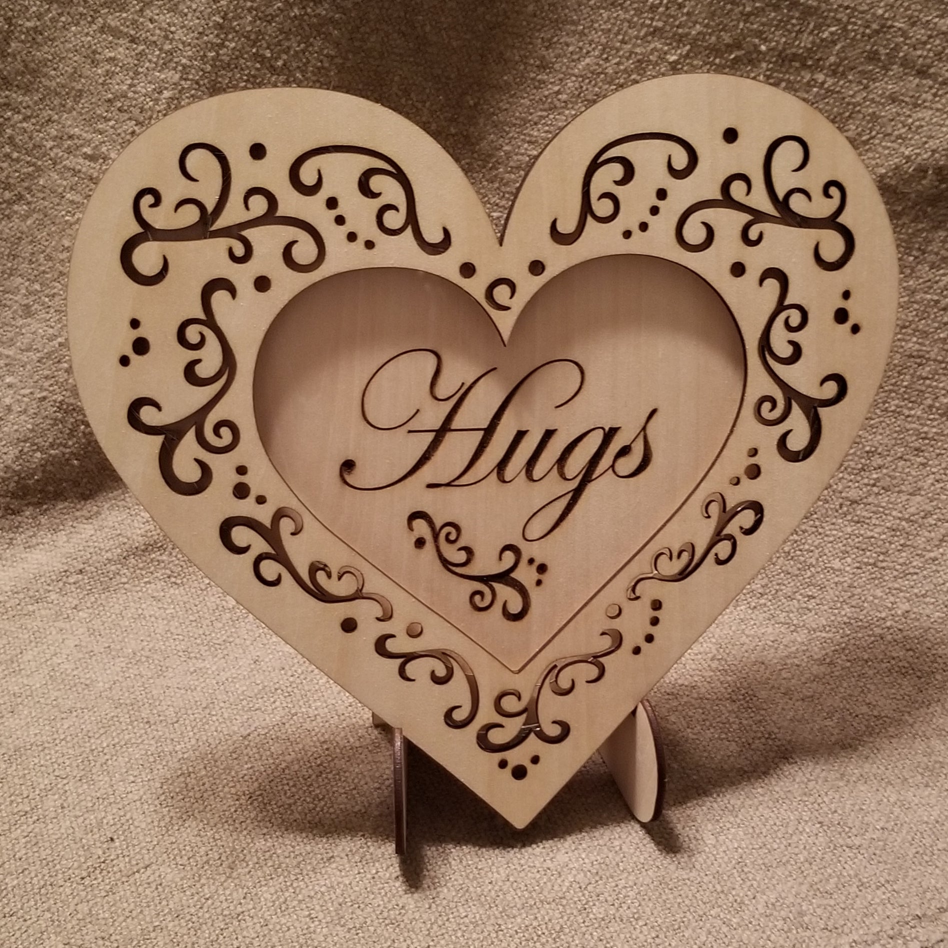 "Hugs" conversation heart with filigree cuts and LED lights. 