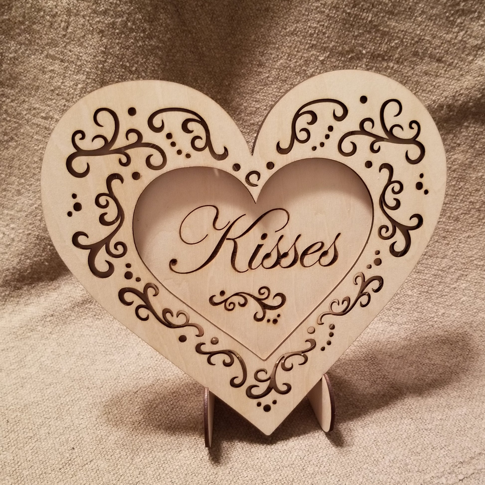 "Kisses" conversation heart with filigree cuts and LED lights. 