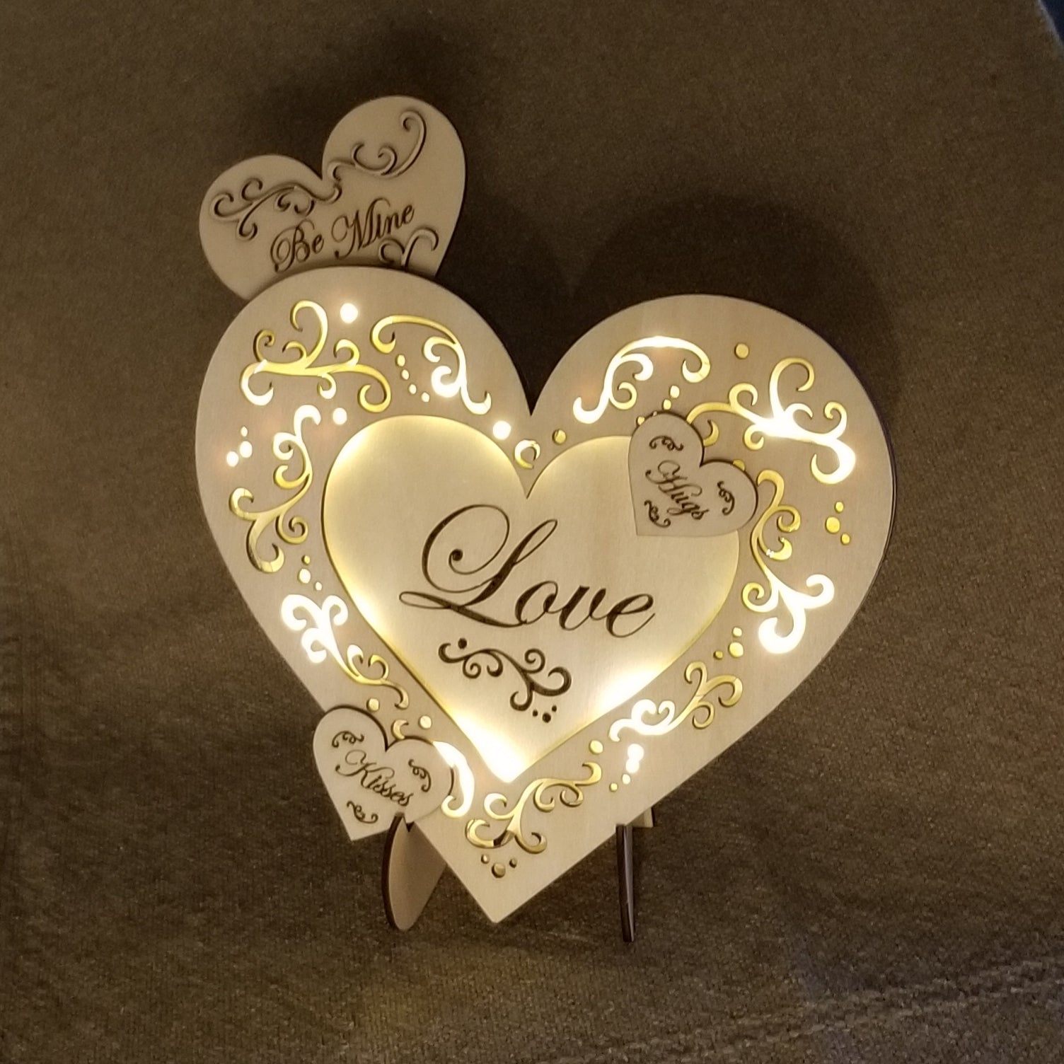 Layered "Love" conversation heart with filigree cuts and LED lights.