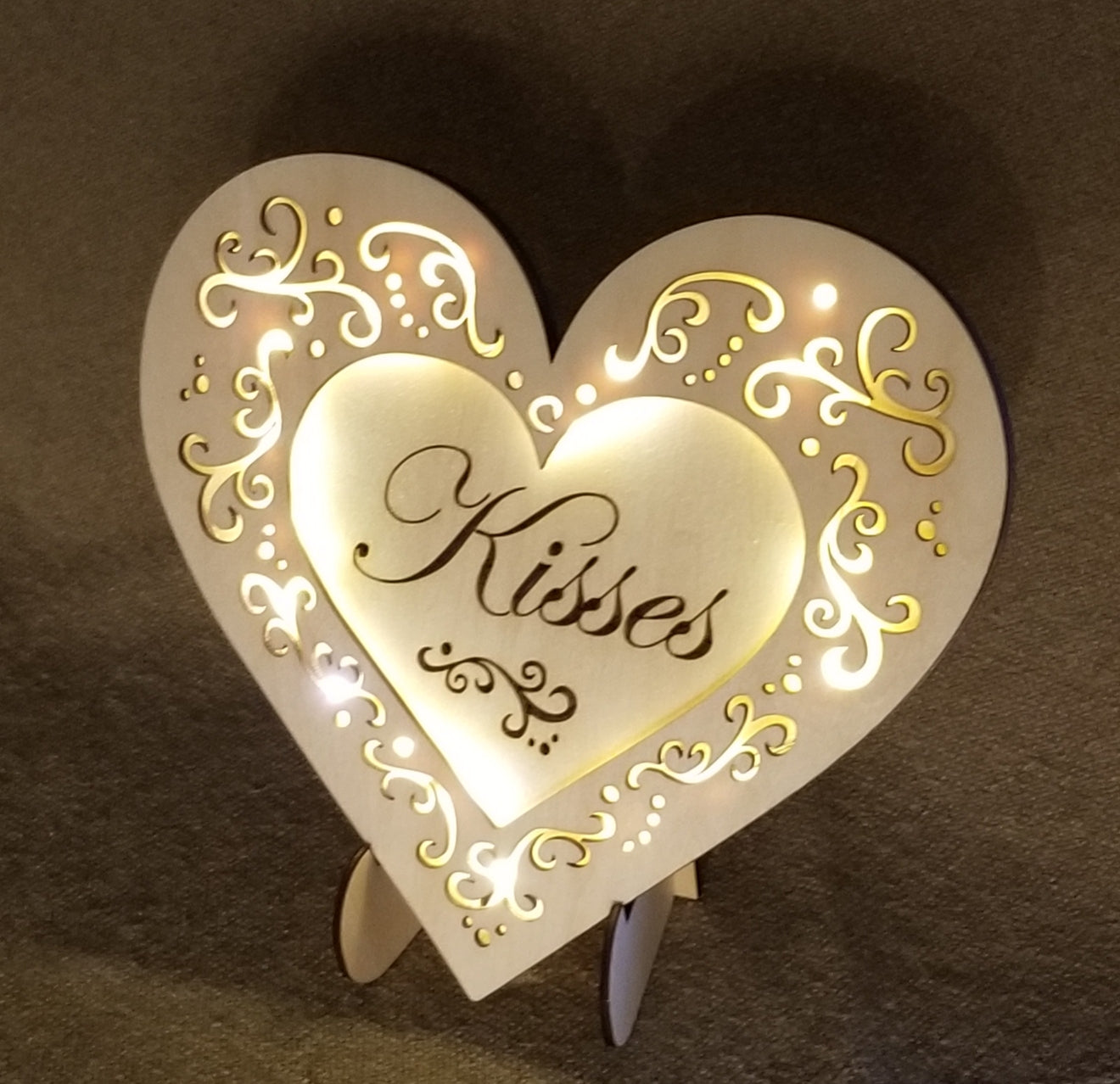 "Kisses" conversation heart with filigree cuts and LED lights. 