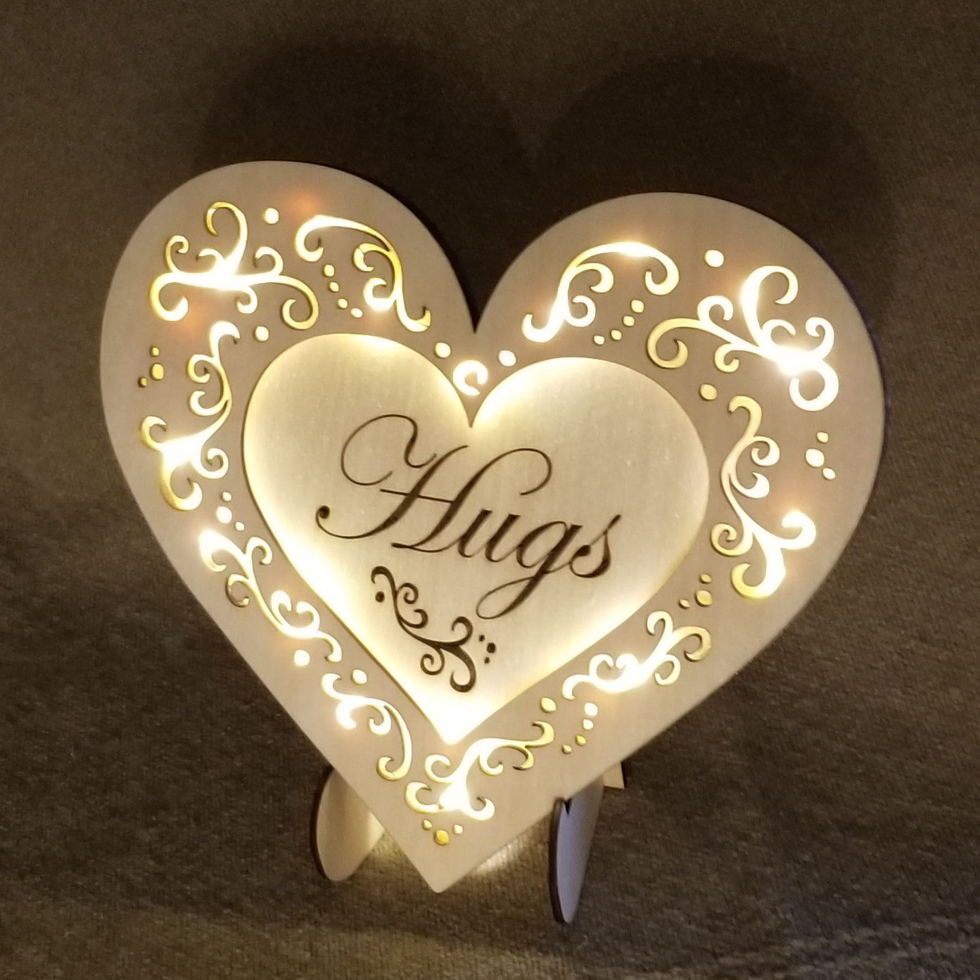 "Hugs" conversation heart with filigree cuts and LED lights. 